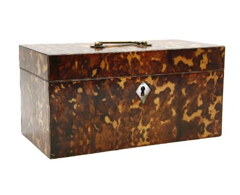A faux tortoiseshell tea caddy, opening to reveal an interior with a central well flanked by two lidded caddies, 30.5cm wide,