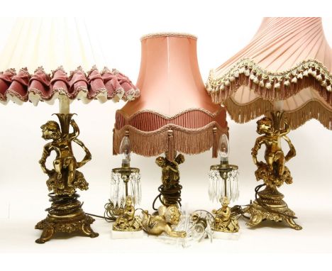 A pair of decorative gilt metal table lamps, the bases in the form of putti, together with a small pair of cherub table lamps