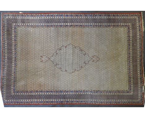 A hand knotted Persian carpet, the turquoise fields with all over stylised decoration