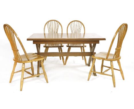 An 'X' frame oak table, and four stick and hoop back chairs, 141cm x 86cm x 75cm high