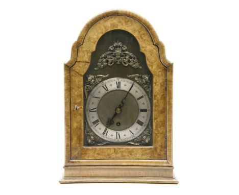 A 20th century walnut mantle clock, with a silvered dial and cherub mask spandrels, by Maple, London