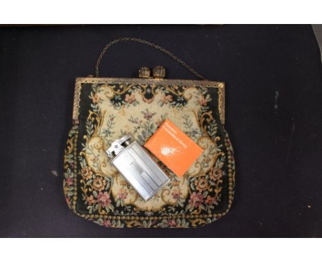 A Ronson petrol lighter, chrome plated with instructions, together with a tapestry evening bag