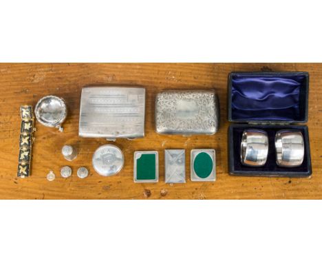 A pair of boxed London 1905 napkin rings, two silver cigarette cases, two silver miniature picture frames, stamp case, pill b
