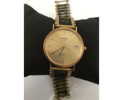 An Imado 9ct gold presentation watch with Quartz movement on a gold plated and black enamel bracelet 