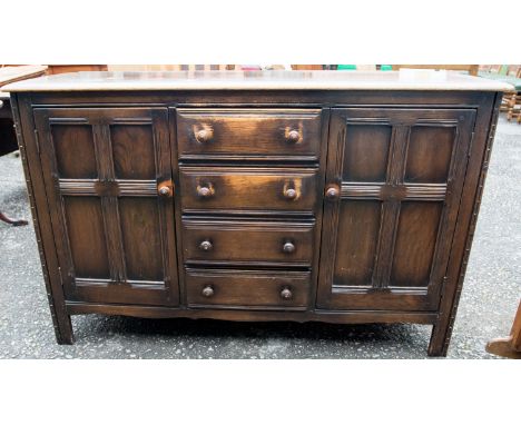 An Ercol dark elm sideboard