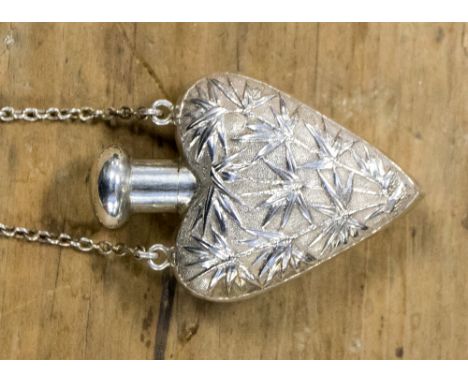 A Chinese silver heart shaped scent bottle with chain, the body chased with bamboo decoration, Wang Hing, Hong Kong, stamped 