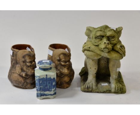 A composite stone gargoyle; together with a pair of gnome jugs and ironstone tea caddy 