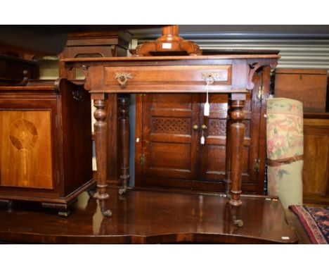 A Victorian walnut single drawer side table, the rectangular top with Art Nouveau fretted bracket supports on four turned leg