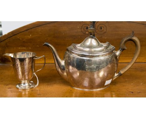 An Edward VII silver oval teapot, of narrow form, with turned wooden handle and finial, London 1904, together with an Edward 