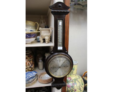 A Victorian wheel barometer, with thermometer incorporated 