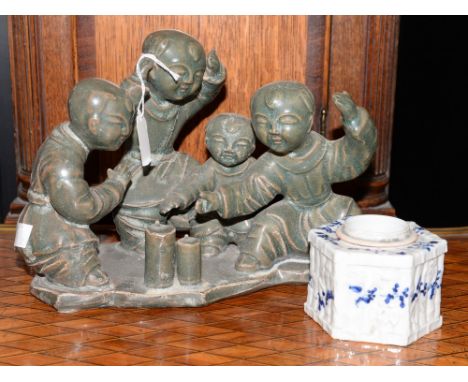 A group of Chinese children playing, with a blue and white ink-well.