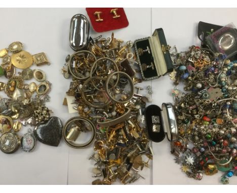 A collection of costume jewellery to include white and gilt metal cufflinks in various designs, along with contemporary charm