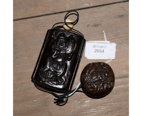 A dark wood/lacquered carved Japanese Inro with Netsuke attached, the Inro depicts a Fisherman holding a Carp type Fish, the 