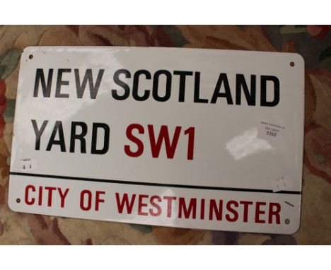 An enamel New Scotland Yard SW1 sign 