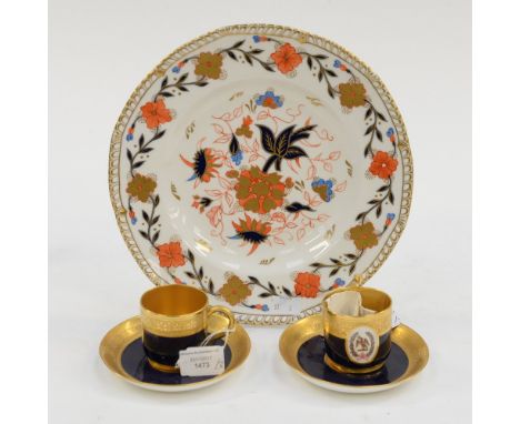 A hand decorated and gilded plate by Irene Griffin; together with two Mintons cobalt and gilt crested coffee cups and saucers