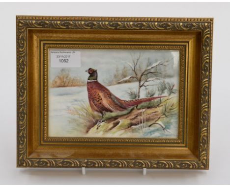 A Royal Worcester framed plaque, signed T. Nutt, Pheasant in the Snow 1986 