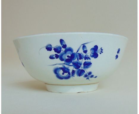 A Worcester blue and white slop bowl, decorated with 'dry Blue' flower sprays and gilt dentil rim, circa 1770, approx 16.5cms