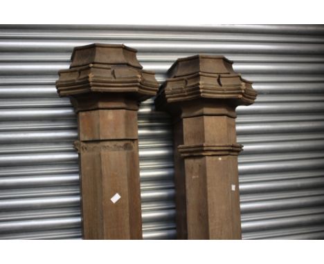A large collection of wooden architectural items, including a pair of newel posts, various turned legs, turned spindles, scro