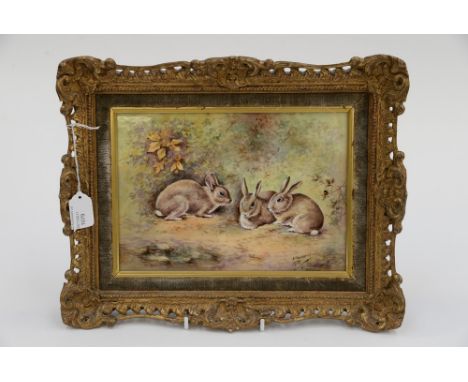 A Royal Worcester framed plaque, signed E. Townsend 1975, three rabbits in hedge bottom 