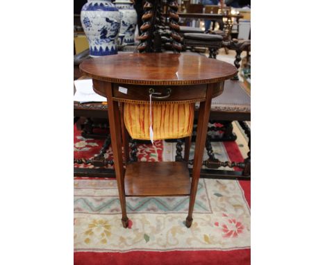 A George III mahogany and satinwood inlaid sewing table, Sheraton style, oval top with spade legs united by a low shelf 