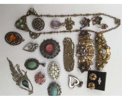 A collection of costume jewellery to include paste set brooches, one micro mosaic brooch, heart pendant, a purple gemset pear