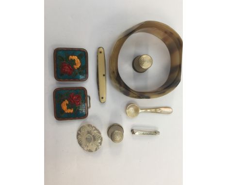 Two silver thimbles, together with an enamelled belt buckle, a mother of pearl brooch and miniature spoon, a bangle and a pen