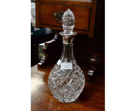 A 1969 silver collared cut glass decanter, possibly Waterford, complete with stopper 