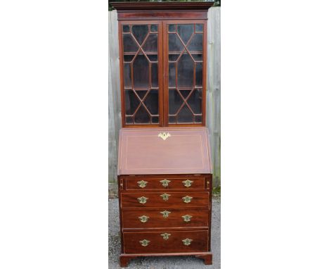 A George III and later bureau bookcase, the upper section with two astragal glazed doors enclosing two fitted shelves, the fa
