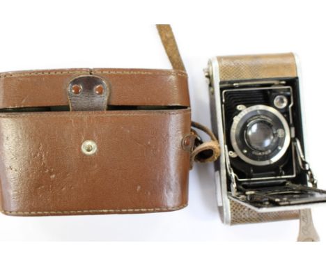 A cased, Krauss Rollette Luxus camera, 1927-1928, snakeskin covering.Provenance: This camera was purchased for 700 cigarettes