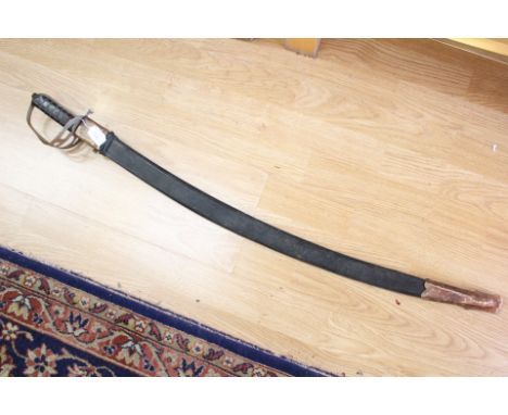 An Indian made decorative sword. 78cm curved blade with etched decoration. Complete with scabbard. Wall decoration item