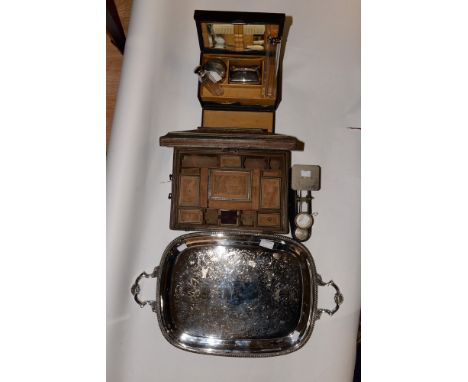 A 19th Century Anglo Indian carved workbox (af) a travelling vanity set, a pair of scales and a silver plated tray (4) 