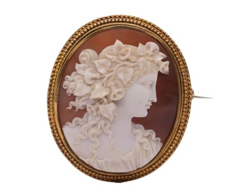 A fine 19th century gold set cameo brooch, comprising an oval carved shell cameo depicting a female classical figure, ivy and