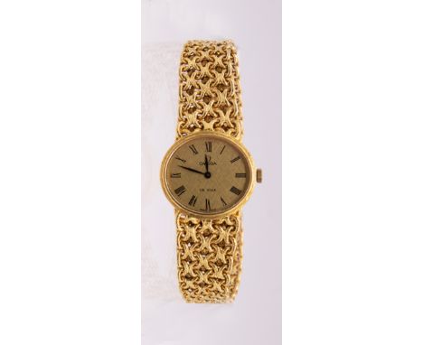 Omega: a Ladies 18ct gold Omega  manual wind wristwatch, comprising an oval signed gold tone dial, with black numeral indices