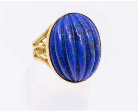 A carved lapis lazuli and 18ct gold ring, comprising a carved oval cabochon lapis lazuli, length approx 18mm, wire work shoul