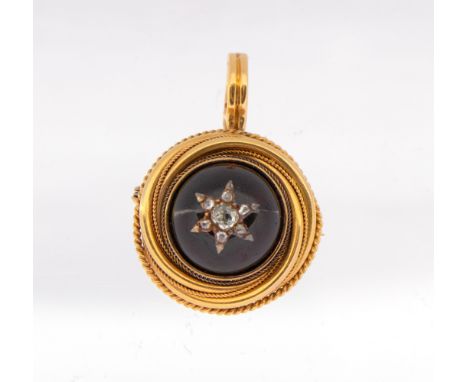 A Victorian garnet and diamond gold set pendant/brooch, comprising a round cabochon garnet approx 14mm, overlaid with a diamo