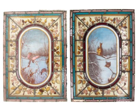 A pair of mid to late 19th century stained glass panels depicting painted Winter landscape with birds in foreground, foliage 