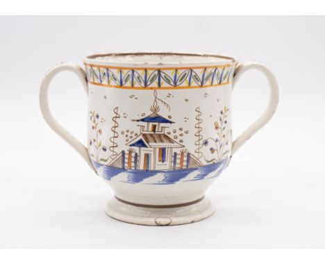 A late 18th/early 19th Century Prattware two handled loving cup, decorated with Chinoiserie scenes, vibrant transfer colourwa