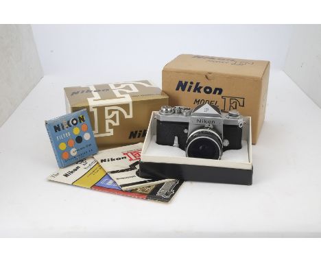 A Nikon F SLR Camera, serial no. 6504640, chrome, eye level finder, shutter working, body, F, some paint loss to corners and 