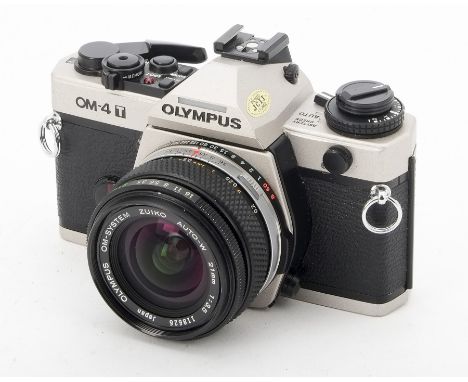 A Olympus OM-4 T SLR Camera, serial no. 1162788, untested, body F-G, some paint loss to film door, with a Zuiko Auto-W 21mm f