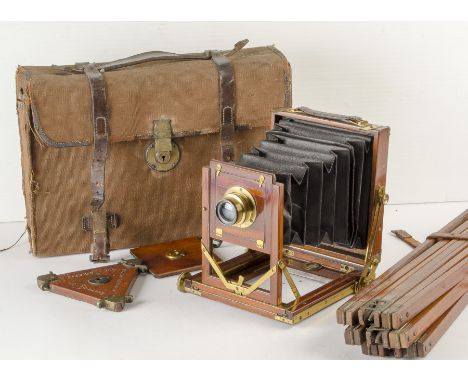 A Reynolds & Branson Ltd Patent 'Rystos' Quarter-Plate Camera, with Goerz f/6.8 Dagor 150mm lens, lens box, and three dds, in