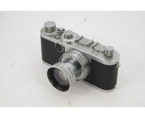 A Leica Ic Camera, serial no. 560660, 1951, chrome, shutter working, body, VG, with a 5cm f/2 Summitar, no. 990859, 1952, bar