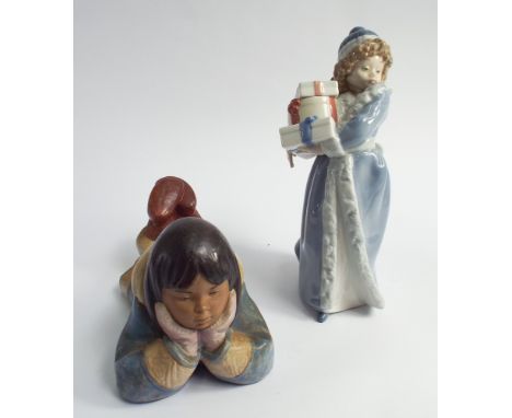 Lladro Nao figure of girl holding christmas presents and a lying down Eskimo girl 