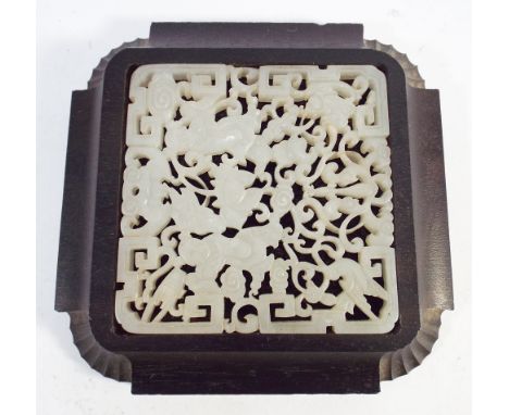 Chinese carved celadon jade pendant or plaque (7.5cm square) in a square carved hardwood stand   Condition : There is a chip 