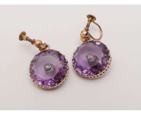 Pair of Victorian circular amethyst earrings, set with large faceted circular cut amethysts with diamond button to the centre