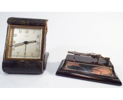 Miniature silver model of a First World War machine gun mounted as a paperweight together with a folding travelling clock Ang