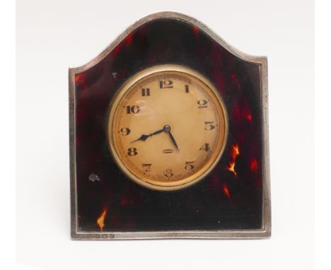 1920s silver framed and tortoiseshell travelling clock.  Height 9.5cm.  Birmingham hallmarks 1927, easel fitting to reverse  