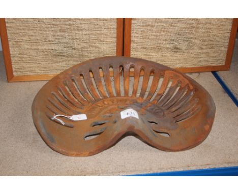 A reproduction tractor seat (109)