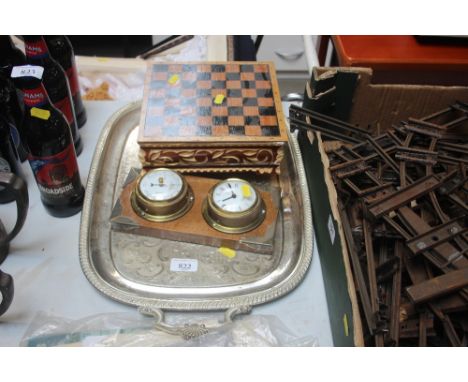 A clock barometer together with a silver plated twin handled tray and a chess board with pieces