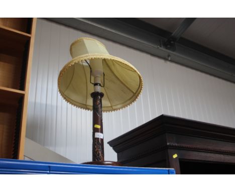 A carved table lamp and shade