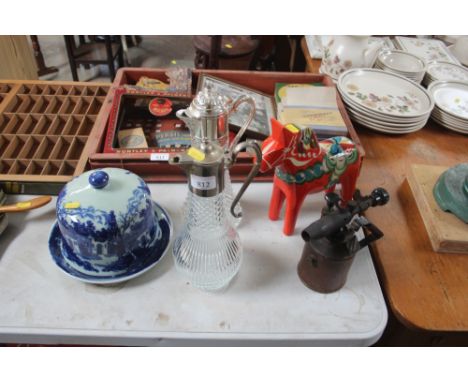 A blue and white cheese dish; together with two claret jugs; a blow lamp etc